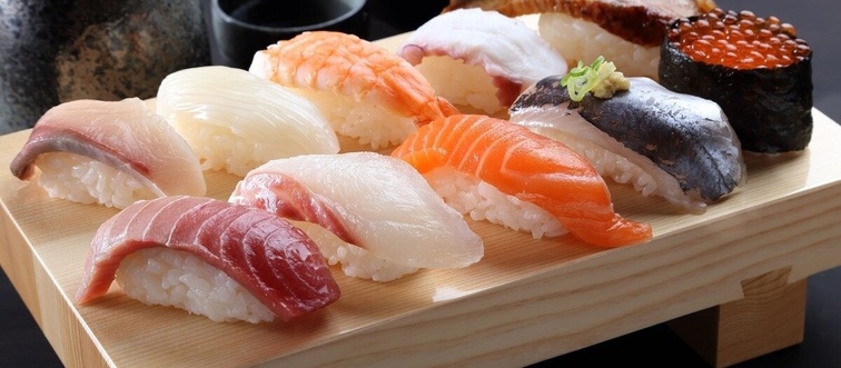 If we trace the origins of Sushi back to its roots, where does this elegant bite of vinegared rice and fish belong?